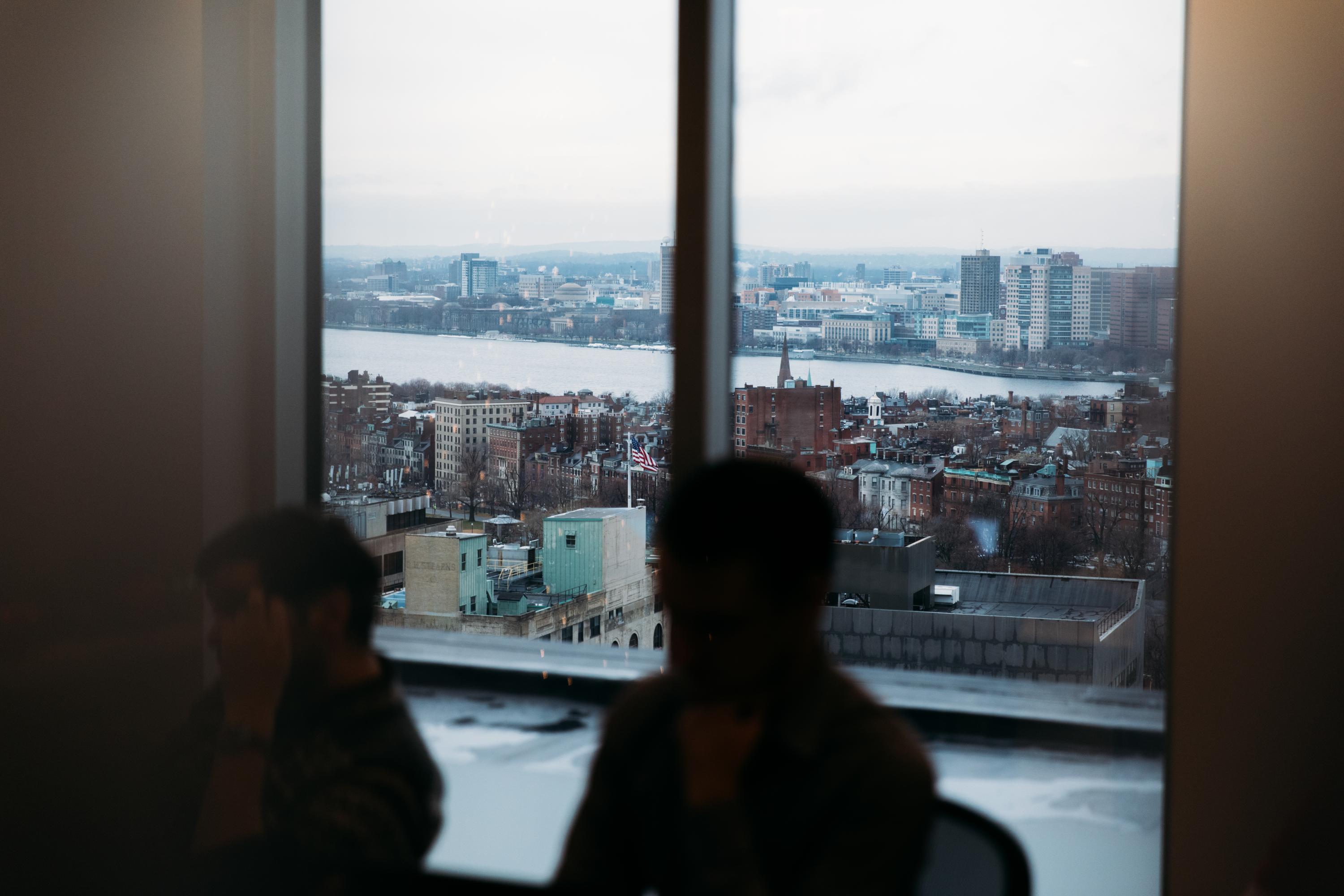 People in office overlooking city