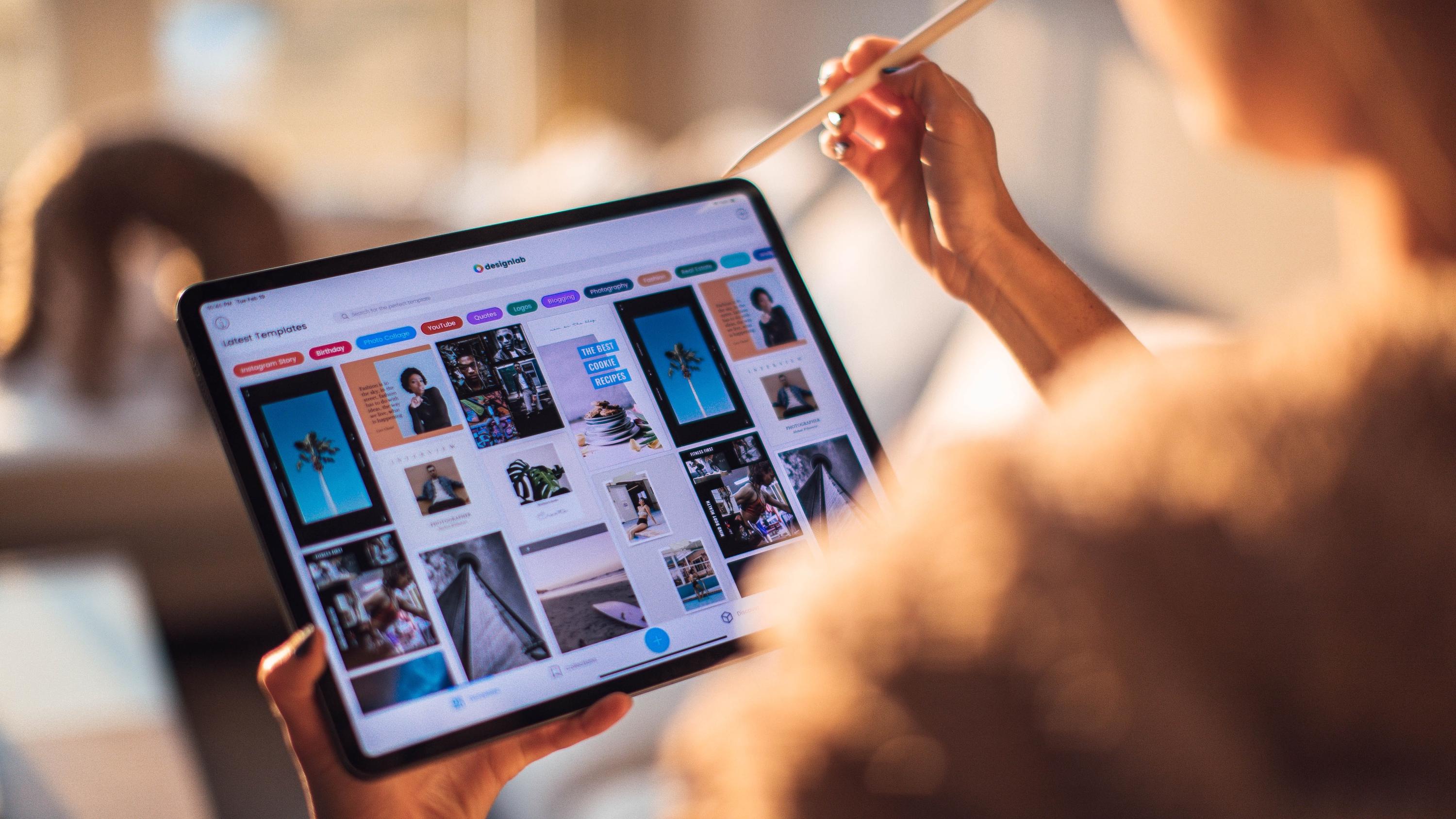 Woman using a stylus to navigate through a page on a tablet