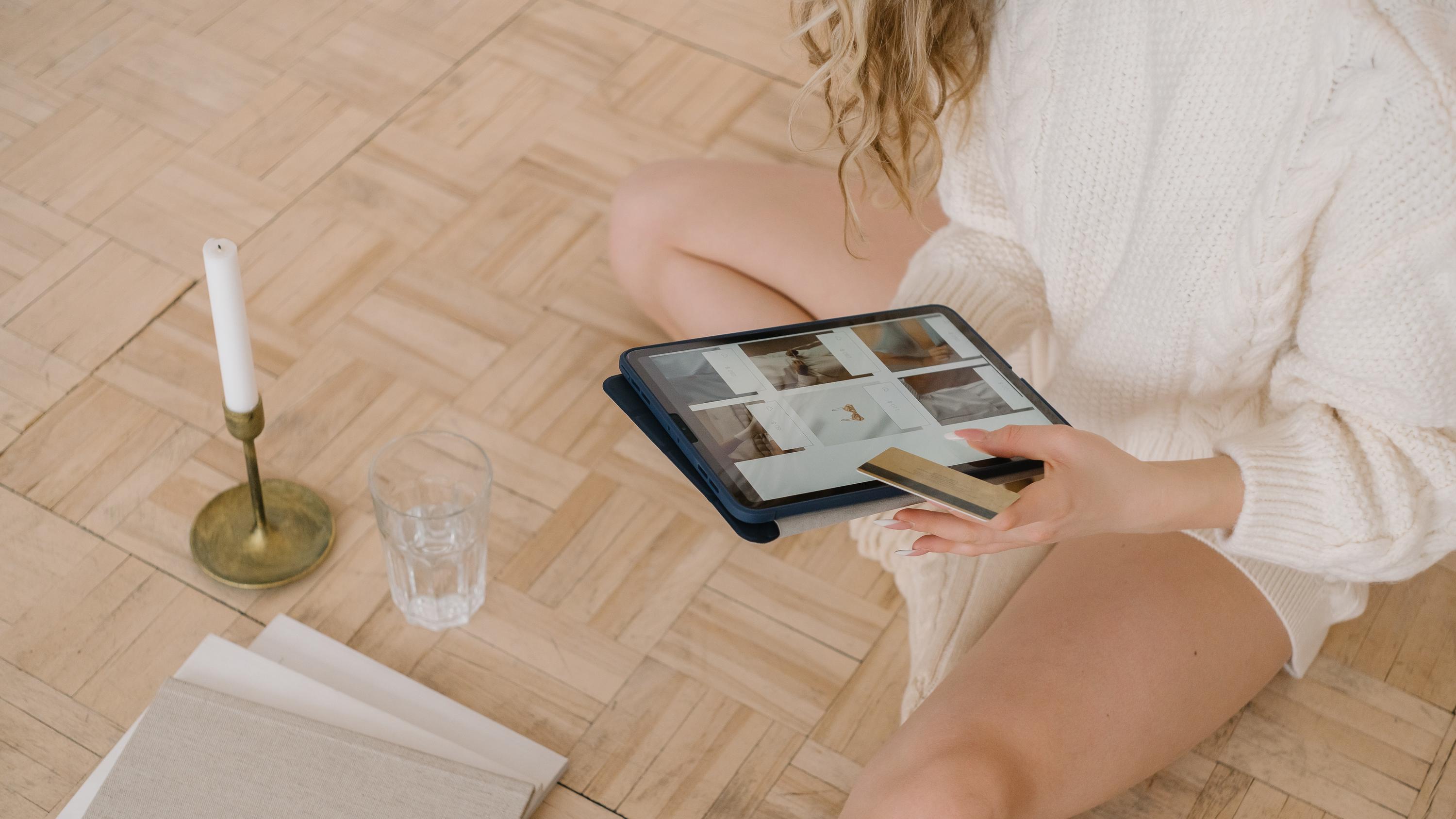 Woman shopping on a tablet with her credit card in hand